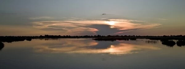 Setting sun over Monachena River near Kwara, Okavango Delta, Botswana