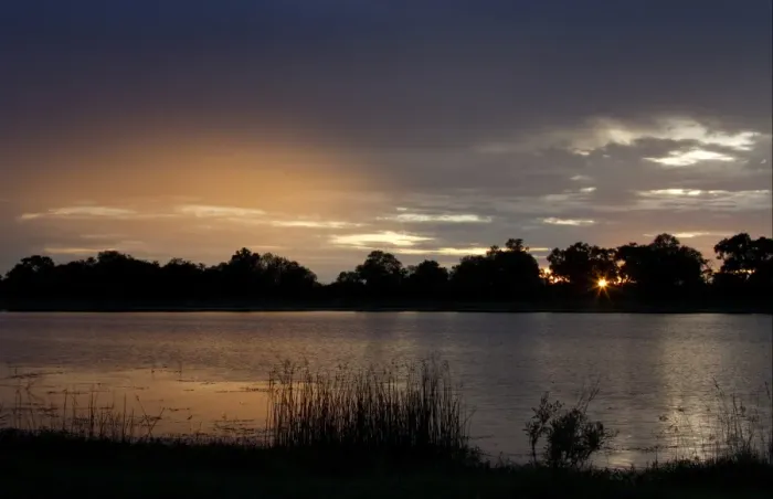 Framed Print : Setting sun over water near Lebala, Okavango Delta, Botswana Framed Print : Setting sun over water near Lebala, Okavango Delta, Botswana