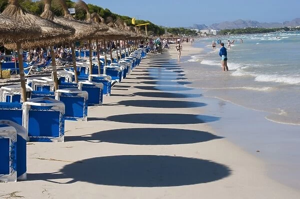 Shadows of beach umbrellas and tourists on sandy beach, Muro, Alcudia, Majorca, Balearic Islands, Spain, September