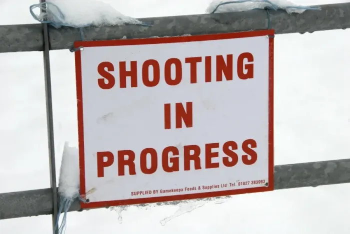 Framed Print : Shooting In Progress sign tied to gate in snow, warning of nearby shoot, near Mayfield, East Sussex, England, January