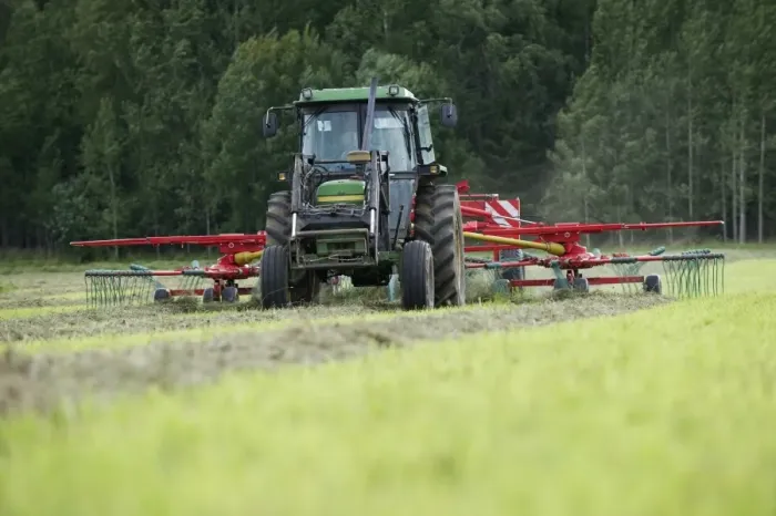 Framed Print : Silage crop, John Deere tractor with double turner, turning cut grass for silage, Sweden, august