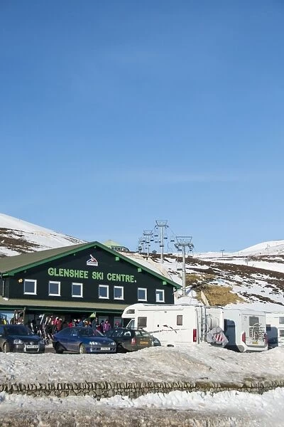 Ski resort carpark, buildings and chairlift in snow, Glenshee Ski Centre, Grampian Mountains, Aberdeenshire, Highlands