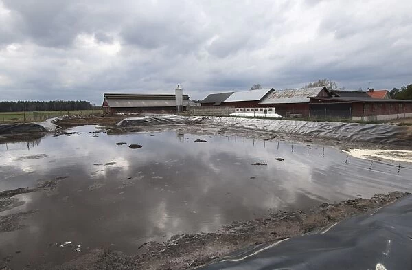 Slurry pond and farm buildings, Sweden, may