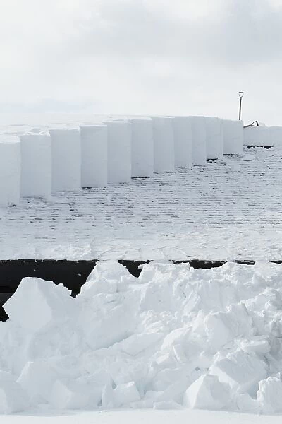 Snow clearance off roof, Canyon, Yellowstone N. P. Wyoming, U. S. A. February