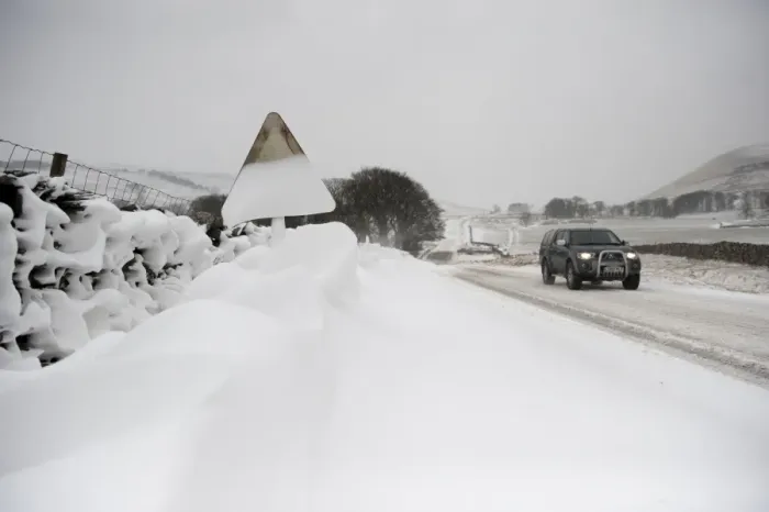 Framed Print : Snow covered roadsign and vehicle travelling along rural road after snowstorm, Cumbria, England, March Framed Print : Snow covered roadsign and vehicle travelling along rural road after snowstorm, Cumbria, England, March
