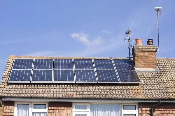 Solar panels for heating domestic hot water, on roof of house, Surrey, England, September