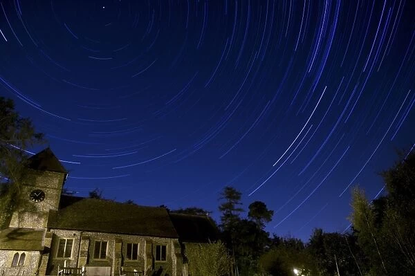 Stars revolving around Polaris (Pole Star) over church at night, Farnborough Church, Farnborough, Kent, England