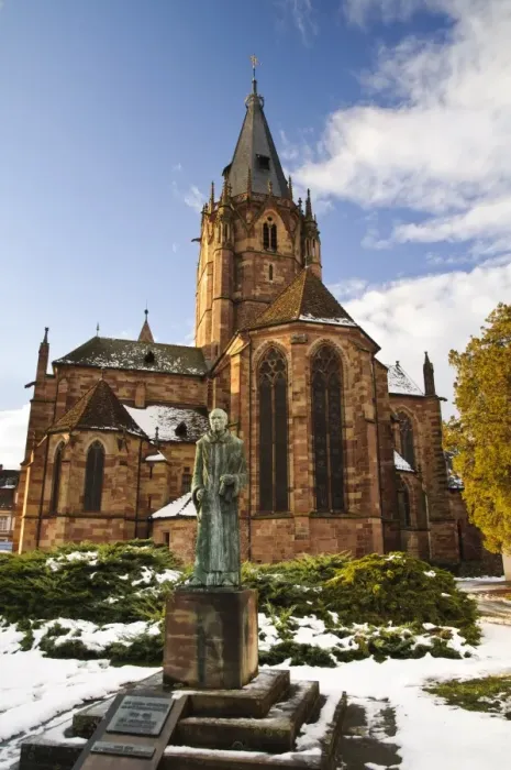 Framed Print : Statue of Benedictine monk and Roman Catholic church in snow, St. Peter and St