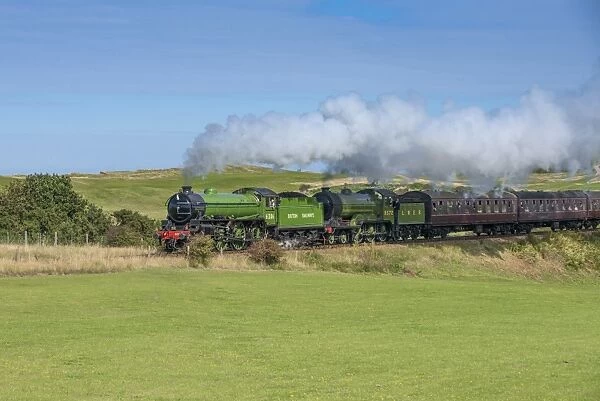 Steam trains and carriages, passing through golfcourse, North Norfolk Railway, Sheringham, Norfolk, England, August