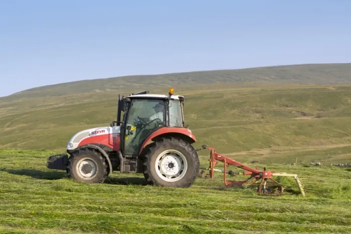 Framed Print : Steyr tractor with tedder, turning grass in upland hay meadow, Cumbria, England, July Framed Print : Steyr tractor with tedder, turning grass in upland hay meadow, Cumbria, England, July