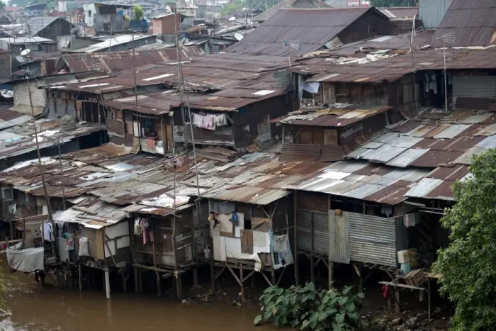 Framed Print : Stilted shacks with corrugated iron roofs beside river in city, Manggarai District, Jakarta, Java, Indonesia, December