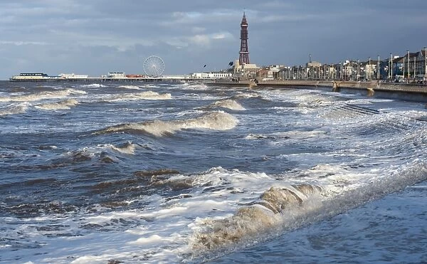 Stormy sea at high tide in seaside resort town, Blackpool Tower in background, Blackpool, Lancashire, England, january