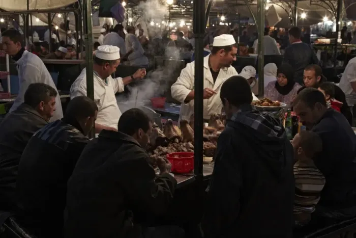Framed Print : Street vendors serving lambs heads at food stall, in market at night, Marrakech, Morocco, february Framed Print : Street vendors serving lambs heads at food stall, in market at night, Marrakech, Morocco, february