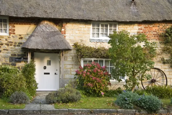 Framed Print : Thatched house with front garden and old wheel propped against wall, Dorset, England, october Framed Print : Thatched house with front garden and old wheel propped against wall, Dorset, England, october