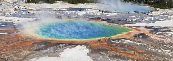 Thermophile bacterial mats and steam rising from hotspring, with tourists on boardwalk, Grand Prismatic Spring