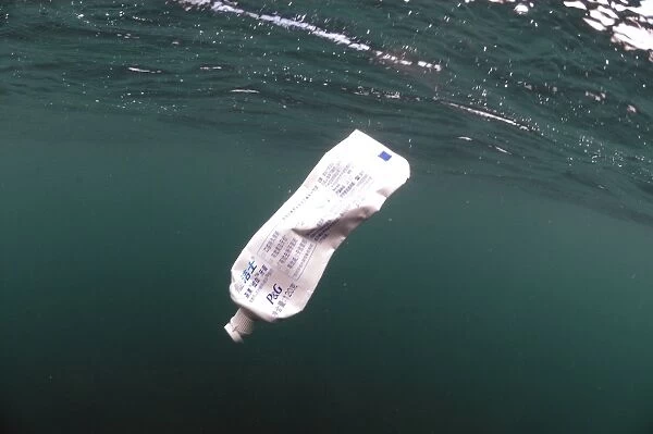 Toothpaste tube floating in sea, Isle of Purbeck, Dorset, England, august