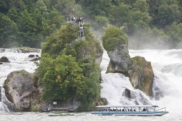 Tourist boat and visitors at largest plain waterfall in Europe, Rhine Falls (Rheinfall), Upper Rhine, Schaffhausen