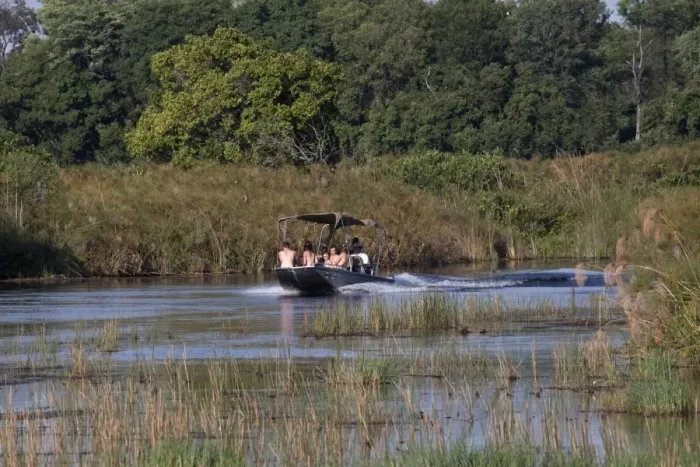 Framed Print : Tourists explore the Monachena River by speed boat. Okavango Delta, Botswana