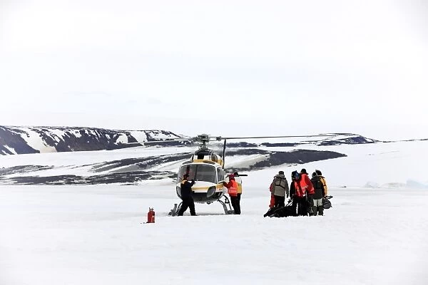 Tourists and helicopter, on snow before departure, Devil Island, Weddell Sea, Antarctica, December