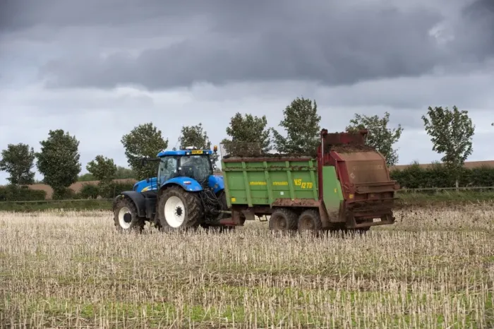 Framed Print : Tractor with muckspeader, spreading chicken manure on oilseed rape stubble field, Kelso, Scottish Borders, Scotland