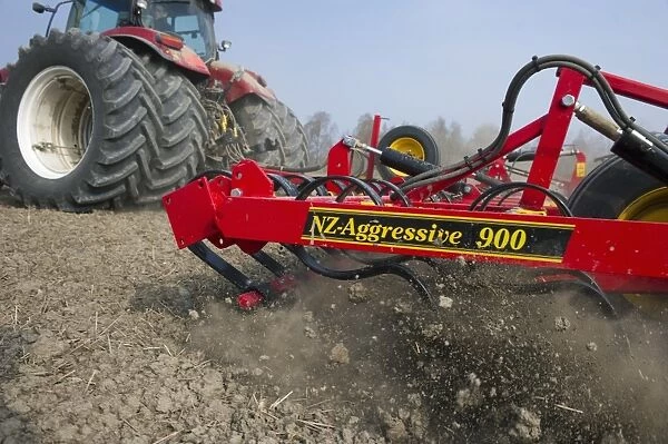 Tractor with Vaderstad NZA-900 harrows, harrowing arable field, Sweden, april