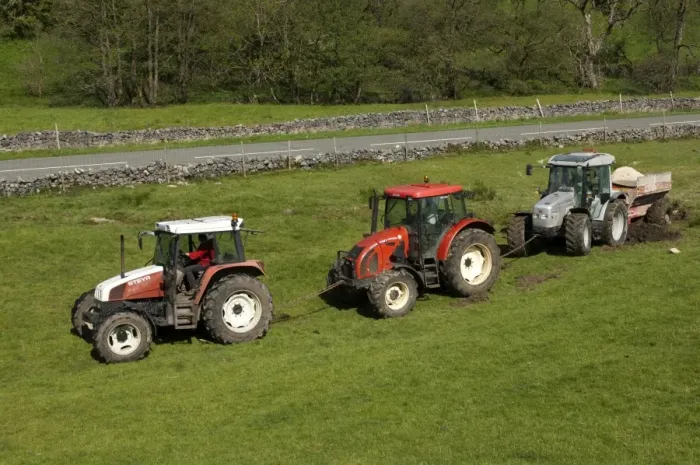 Framed Print : Tractors linked together pulling out tractor and limespreader stuck in field, Cumbria, England, May Framed Print : Tractors linked together pulling out tractor and limespreader stuck in field, Cumbria, England, May