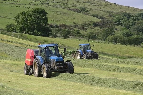 Tractors rowing and baling haylage in field, Chipping, Forest of Bowland, Lancashire, England, June