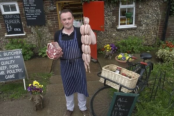 Traditional village butcher outside shop, Sandridgebury, Hertfordshire, England, april
