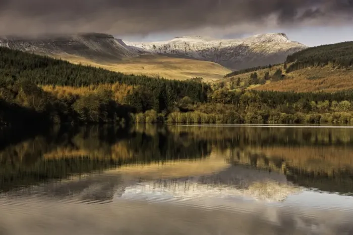 Framed Print : Trees and snow covered hills reflected in reservoir at sunrise, Penyfan and Corn Du, Taf Fechan Reservoir Framed Print : Trees and snow covered hills reflected in reservoir at sunrise, Penyfan and Corn Du, Taf Fechan Reservoir