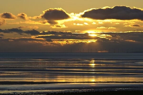View across bay with offshore windfarm in distance at sunset, Humphrey Head, Morecambe Bay, Cumbria, England, December