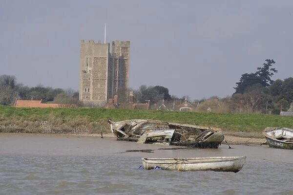 View of boat wrecks on coastal river with Medieval keep in distance, Orford Castle, River Ore, Orford Ness, Orford