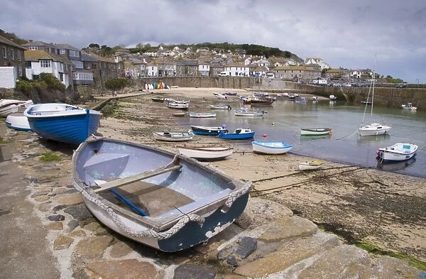 View of boats and coastal fishing village, Mousehole, Cornwall, England, May