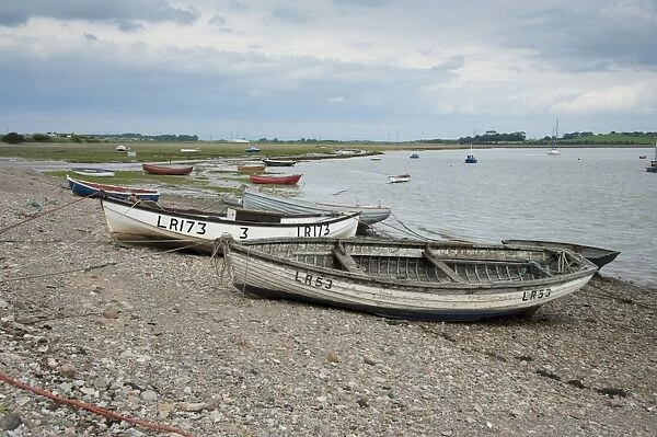 View of boats on shoreline at coastal village, only community on U. K. mainland dependent upon tidal access