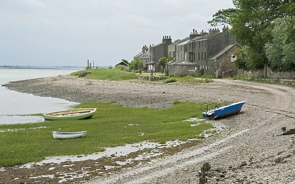 View of boats on shoreline and houses of coastal village, only community on U. K