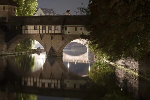 View of bridge over river in city at night, River Pregnitz, Nuremberg, Bavaria, Germany, september