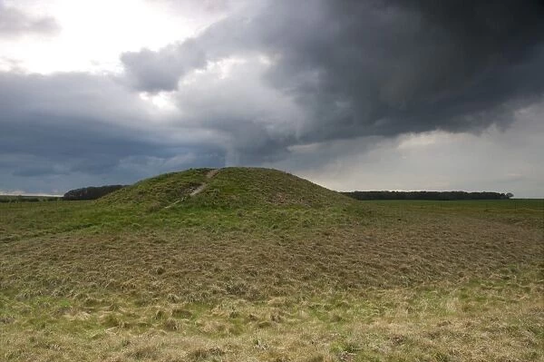 View of Bronze Age round barrow and approaching stormclouds, Normanton Down, Stonehenge, Salisbury Plain, Wiltshire