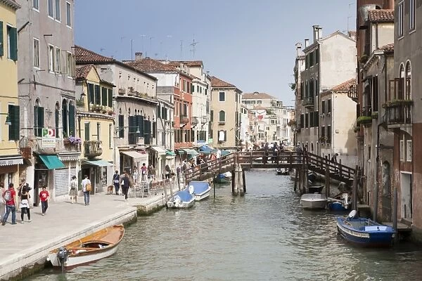 View of canal, footbridge and canalside street, Fondamenta Ormesini, Canareggio District, Venice, Veneto, Italy, May