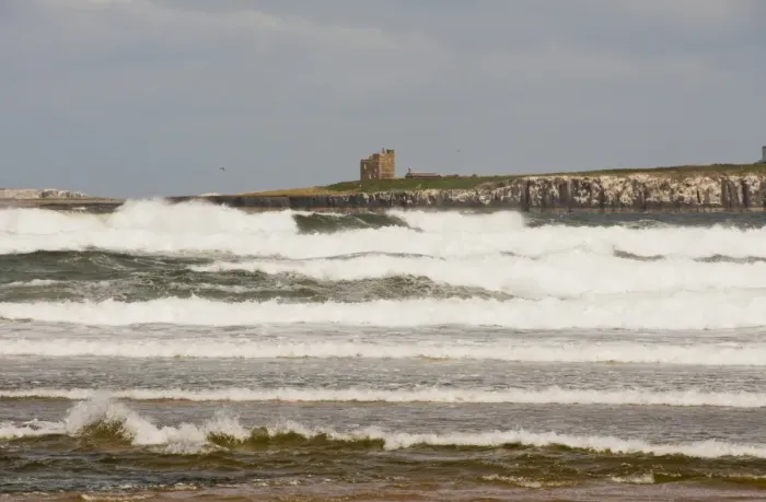 Framed Print : View of chapel and tower on island in rough sea, Inner Farne, looking across Inner Sound, Bamburgh, Northumberland