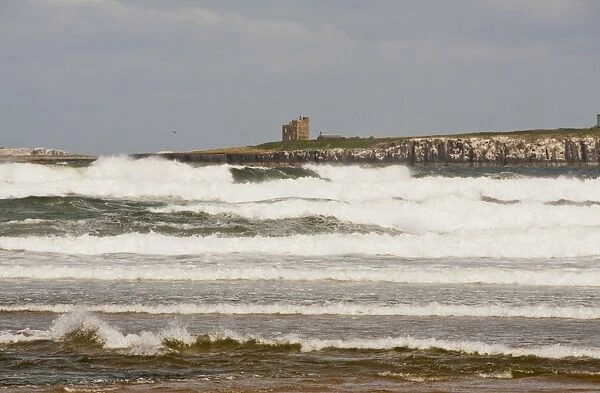 View of chapel and tower on island in rough sea, Inner Farne, looking across Inner Sound, Bamburgh, Northumberland