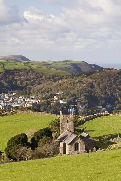 View of church, village, woodland and coastline on sunny morning, Church of St