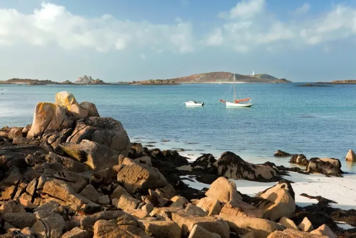 Framed Print : View of coast with two small boats moored, looking across to St. Helens and Round Island, Cradle Porth