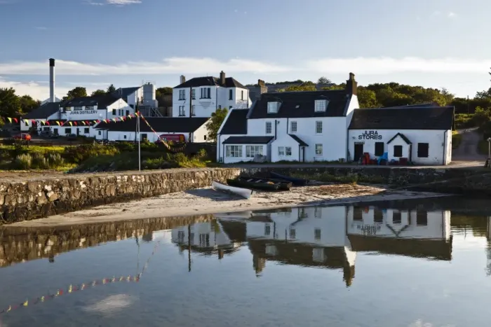 Framed Print : View of coastal village, Jura Distillery, Lodge, Cooperage and Jura Stores, Craighouse, Isle of Jura, Inner Hebrides