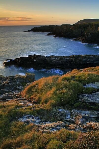 View of coastline and cliffs at sunset, South Stack Cliffs RSPB Reserve, Anglesey, Wales, September