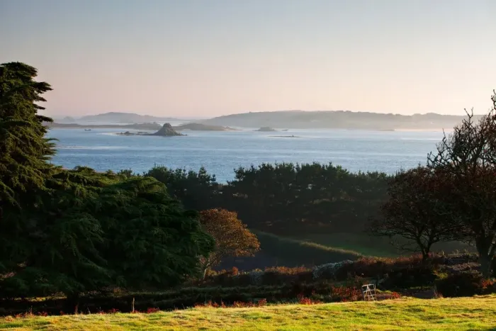 Framed Print : View of coastline with lifting sea mist at at sunrise, St. Martins visible in distance, Borough Farm, Tresco Framed Print : View of coastline with lifting sea mist at at sunrise, St. Martins visible in distance, Borough Farm, Tresco
