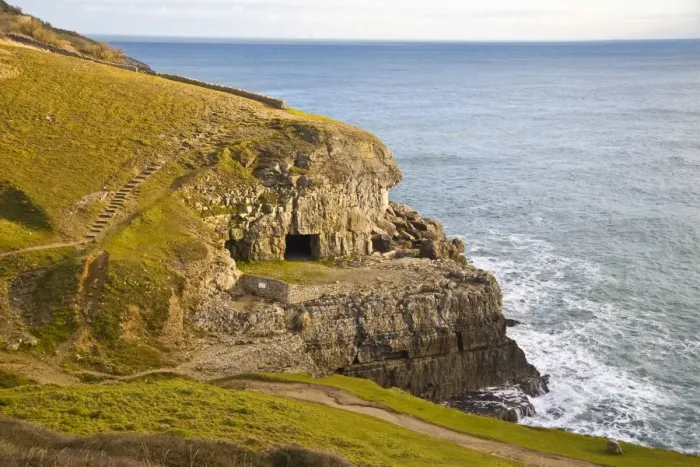 Framed Print : View of coastline with manmade caves in cliff, former Purbeck Stone limestone quarry, Tilly Whim Caves, Durlston