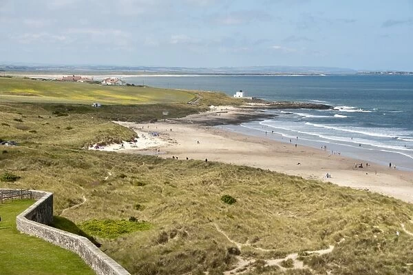 View of coastline with sand dunes and beach, Bamburgh, Northumberland, England, july