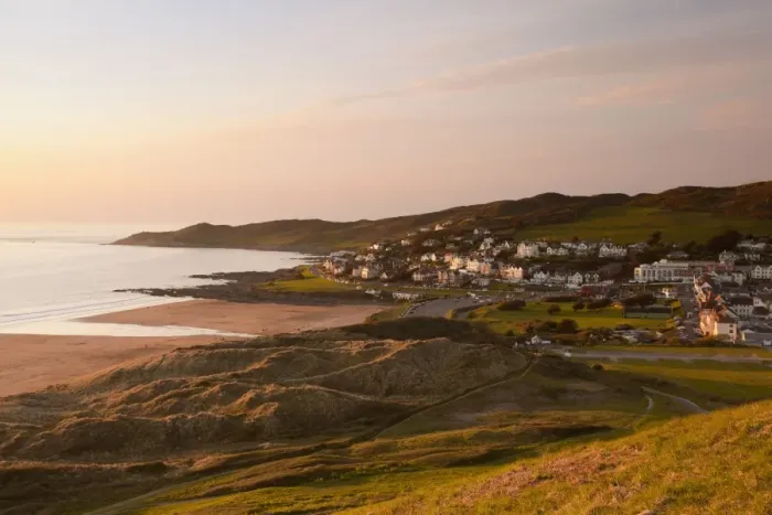 Framed Print : View of coastline and seaside resort at sunset, with Morte Point in distance, viewed from Potters Hill, Woolacombe Framed Print : View of coastline and seaside resort at sunset, with Morte Point in distance, viewed from Potters Hill, Woolacombe