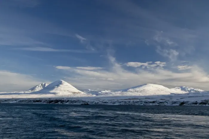 Framed Print : View of coastline with snow covered mountain peaks in background, Paps of Jura, viewed from Sound of Jura