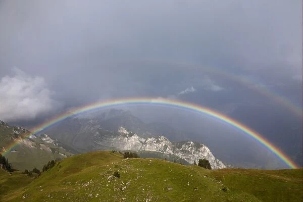 View of double rainbow over mountain landscape, Schynige Platte, Bernese Oberland, Switzerland, August