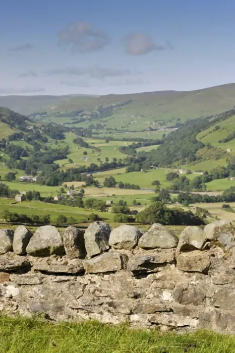 Framed Print : View over drystone wall across river valley with farmland, looking up Swaledale towards Gunnerside from Whitaside Moor